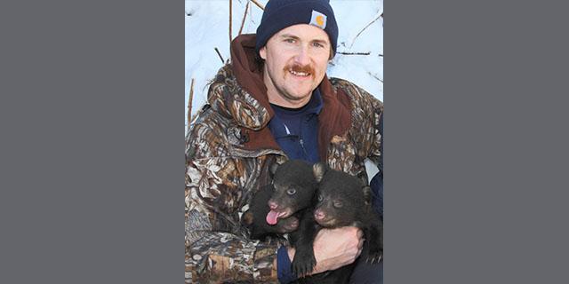 Photo of John Cox and bear cubs Photo of John Cox and bear cubs